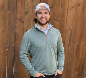 Man wearing Moisture Wicking Quarter Zip Pullover, front view with hands in pockets