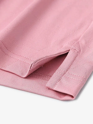 Close-up detail of hem opening on Modern Texture Stylish Polo in CARMINE.