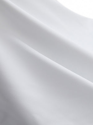 Close-up texture of white flat front golf joggers pants with belt loops fabric showing detailed material and weave.