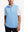 Upper body front view of model wearing light blue melange lightweight sleeveless quarter zip golf vest