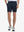 Front view of model’s lower body with hands in pockets, wearing Player Fit Versatile Solid Shorts 7 Inch – NAVY