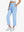 Front lower-body view of model with right hand in pocket wearing LIGHT BLUE Women's 7/8 Ankle Golf Track Pants.