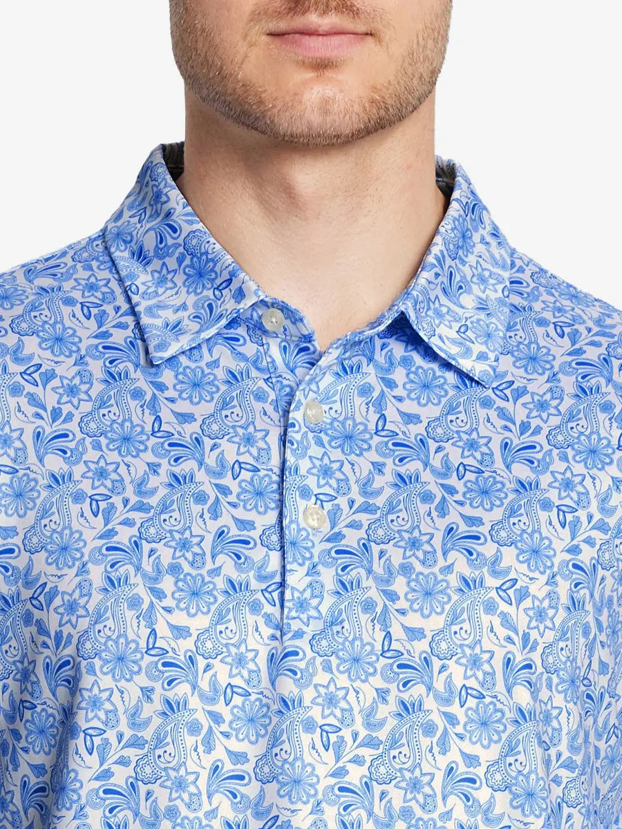 The model wears the WHITE PAISLEY golf polo shirt, seen from the chest, highlighting its cut and comfort