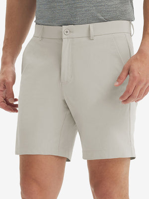 Front lower body shot of model wearing the light khaki stretch soft flat front dress golf shorts, showcasing the fit