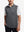 Upper body front view of model wearing black melange lightweight sleeveless quarter zip golf vest