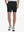 Front view of model’s lower body with hands in pockets, wearing Player Fit Versatile Solid Shorts – BLACK