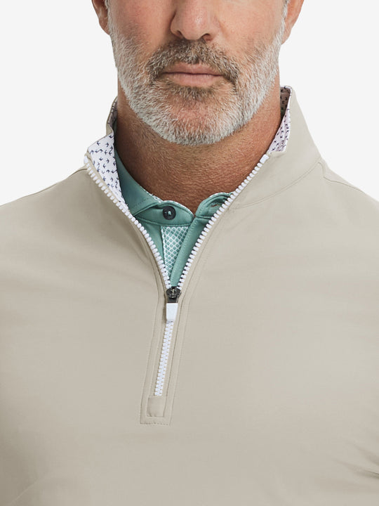 Close-up from nose to chest, showing collar and zipper detail of the khaki light golf pullover.