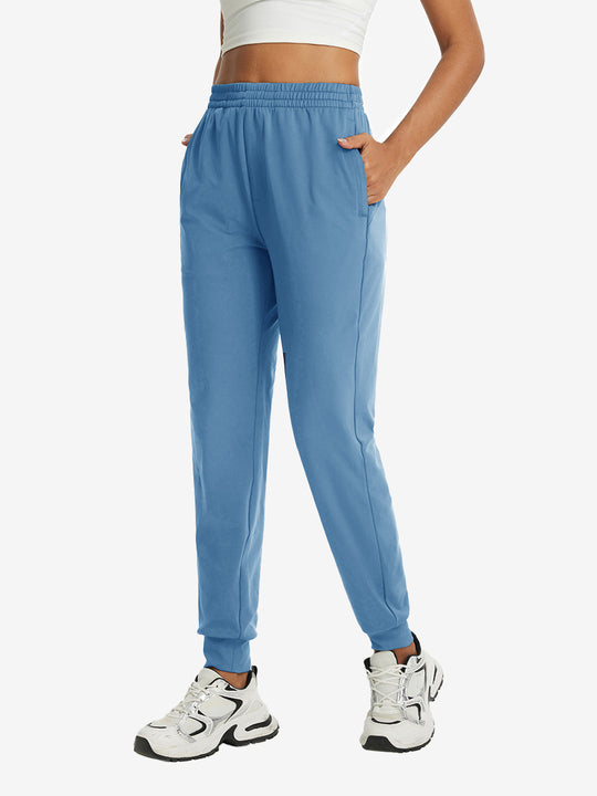 Model with hand in pocket wearing lightweight women's stretchy joggers sweatpants in misty blue.
