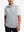 Upper body front view of model wearing lunar rock melange lightweight sleeveless quarter zip golf vest