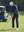 Model in misty blue softshell water resistant lightweight jacket preparing to tee off, full-body shot