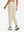 Model wearing women's stretch fleece lined water resistant joggers in light khaki, showing the back lower body view.