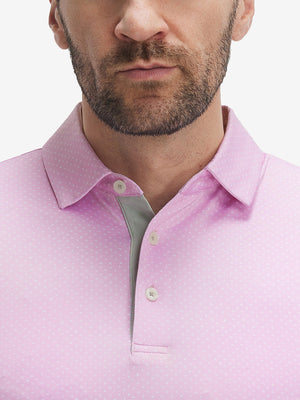Front view from nose to chest of model wearing pink white tee performance quick dry print golf polos