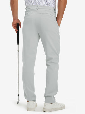Back lower-body view of lightweight moisture wicking dress pants, model with golf club in silver grey.