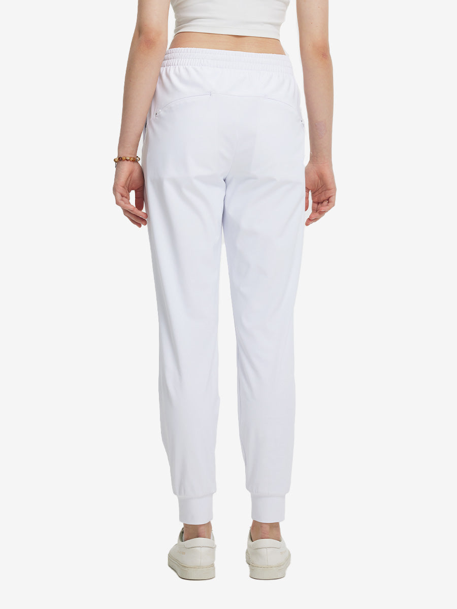 Back view of lightweight women's stretchy joggers sweatpants on model, shown in white.
