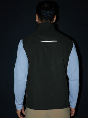 Model back half-body shot showcasing sleeveless softshell fleece outdoor vests with 6 pockets in grey