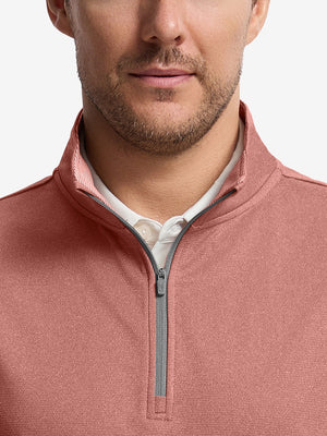 Front shot from nose to chest of model wearing brick melange  lightweight sleeveless quarter zip golf vest