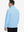 Back upper body view of the light blue lightweight golf pullover, model turns head slightly with ease.