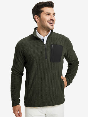Model with one hand in side pocket, wearing midweight warm stretchy quarter zip pullover in forest green.