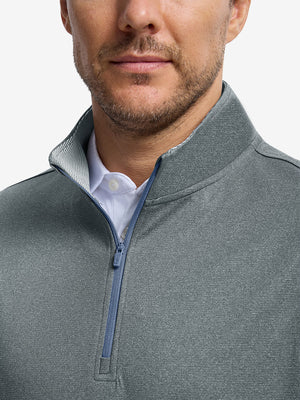 Front shot from nose to chest of model wearing grey melange lightweight sleeveless quarter zip golf vest