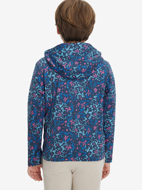 Back upper body view of model wearing youth full print stylish hoodies pullover, navy colorful flower.