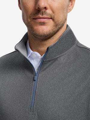 Front shot from nose to chest of model wearing black melange lightweight sleeveless quarter zip golf vest