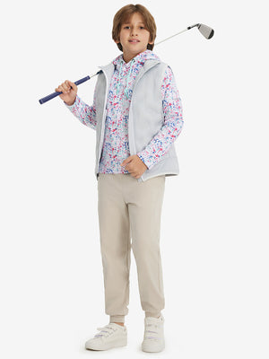 Full-body shot of model wearing light khaki fleece stretch water resistant boys joggers while holding a golf club.