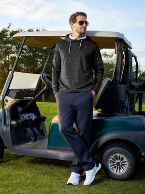 Model in dark grey heather fleece hoodies pullover leaning on a golf cart on the course