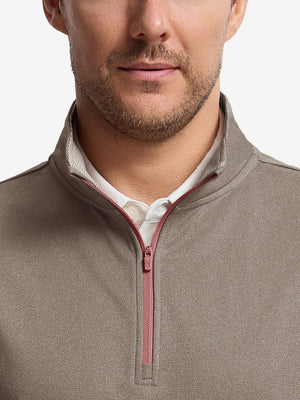 Front shot from nose to chest of model wearing brown melange  lightweight sleeveless quarter zip golf vest