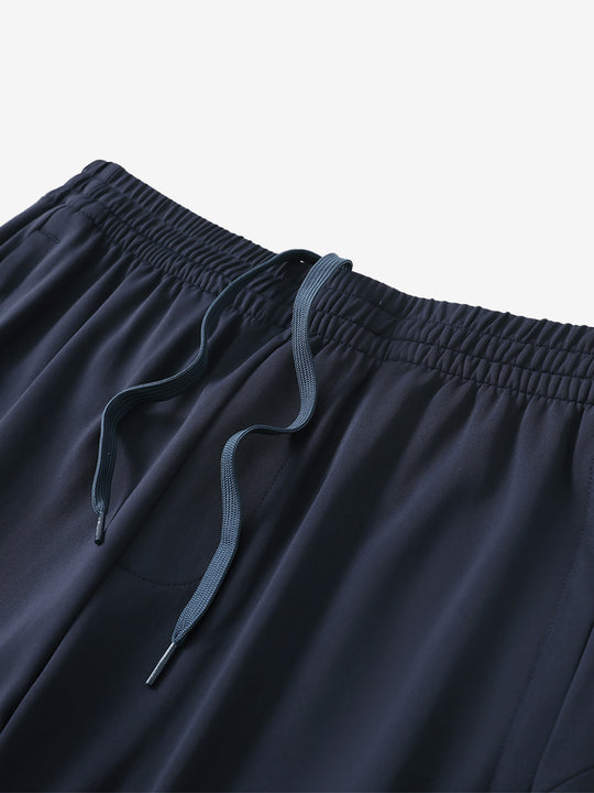 Angled view of lightweight women's stretchy joggers sweatpants waistband displayed in navy.