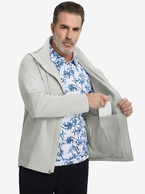 Model placing an iPhone into the inner pocket of the lightweight water-repellent softshell hooded jacket in glacier grey.