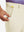 Hand placing a golf ball into pocket of water-resistant golf stretch nylon pants in beige.