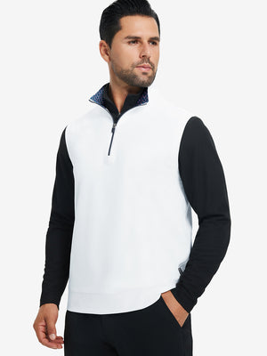 Model with hands in pockets, wearing print collar quarter zip golf vest in white, casual look.