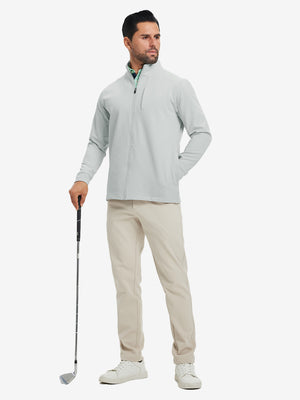 Model holding a golf club, wearing silver grey water-resistant zip up golf jacket in full-body view.