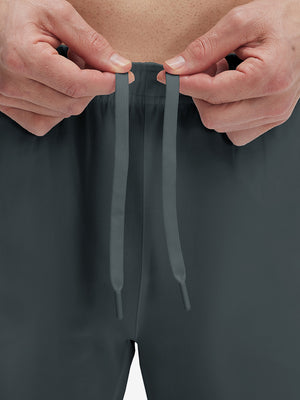 Close-up of elastic waistband on dark grey superion softness mesh joggers with zipper pockets