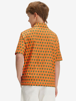 Back half-body of boy in orange cactus  performance print boys golf polo