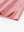 Hem slit detail of PINK HEATHER Premium Stretch Heather Polo highlighting stitching and finish.
