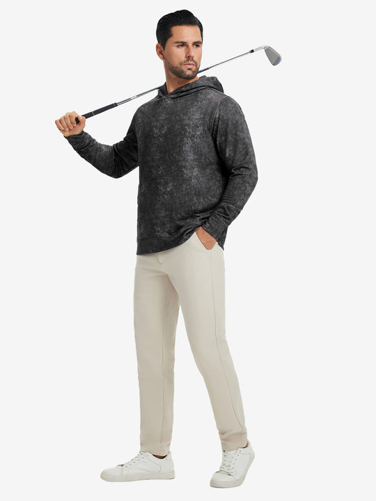 Full-body view of model in black exclusive print kangaroo hoodies holding a golf club outdoors.