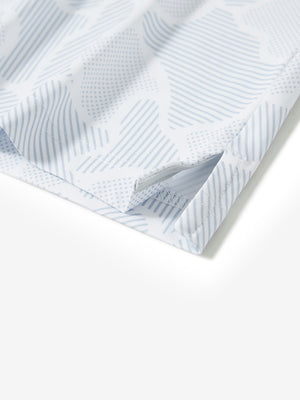 Hem slit detail of the light gray irregular pattern lightweight print long sleeve polo, showing fine stitching and finish.