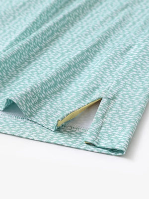 Hem slit detail of MAELREG Performance Jersey Print Polo in Green White Fish – comfort & movement