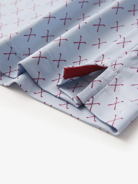 Detail view of the grey and burgundy combo polo shirt, highlighting the tailored hem opening for a sleek look.