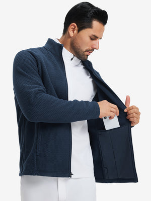 Model showing inner pocket of soft winter fleece jackets in navy, fitting an iPhone inside.