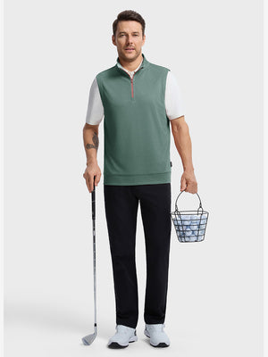 Front full body shot of model wearing dark green melange lightweight sleeveless quarter zip golf vest, holding a golf club in one hand and carrying a basket of golf balls in the other hand