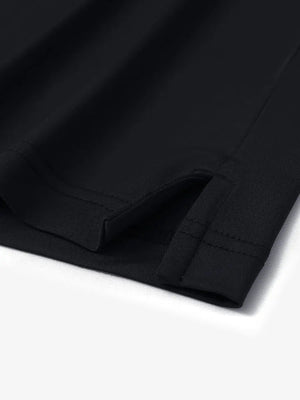 Close-up of hem slit on Everyday Solid Jersey Polo in BLACK, showcasing precise stitching and finish.