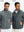 The model showcases a dark grey reversible fleece jacket with 5 pockets, highlighting its two-in-one reversible design.