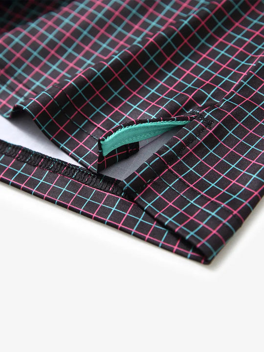 Hem slit detail of BLACK GRID Performance Quick Dry Print Golf Polo highlighting stitching and finish