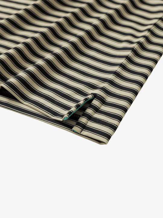 Close-up of the hem slit on the Black Khaki Yarn Dyed Stripe Polo – tailored for comfort and mobility