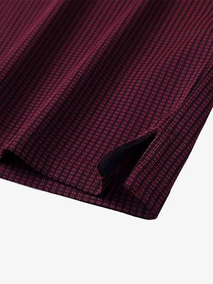 Close-up of hem slit detail on RED Elegant Performance Jacquard Polo