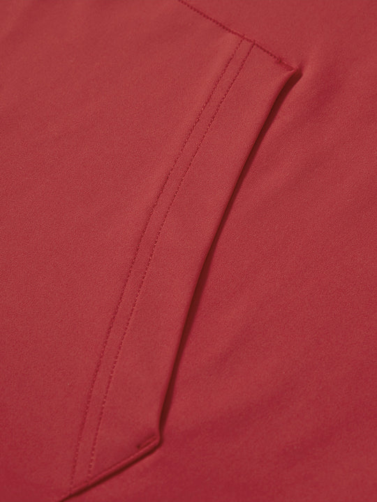 Close-up of single pocket detail on youth long sleeve hoodied with kangaroo pocket in red, showing stitching.