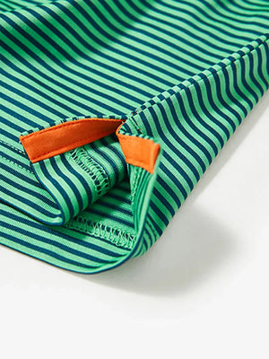 Close-up detail of side hem slit on Cooling Stripe Golf Shirt in GREEN STRIPE, emphasizing comfort and finish