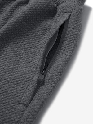Detail of zipper pocket on soft sweatpants with 4 zipper pockets in grey heather